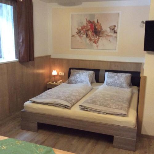 a bedroom with a bed with two pillows on it at Weitlaner Birgit in Sillian