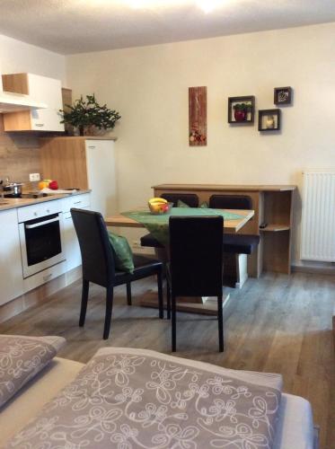 a kitchen and living room with a table and chairs at Weitlaner Birgit in Sillian