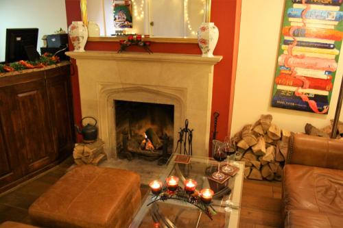 a living room with a fireplace with a fire place at Castle House Hotel in Canterbury