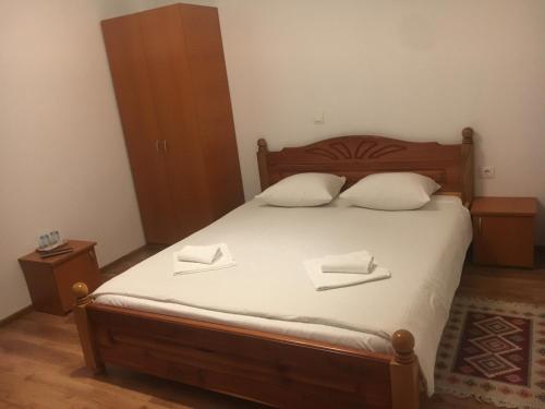 a bedroom with a bed with two pillows on it at Pensiunea Magnolia in Ocna Şugatag