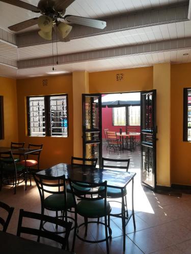 a dining room with a table and chairs at Sunview Lodge & Restaurant in Libwezi