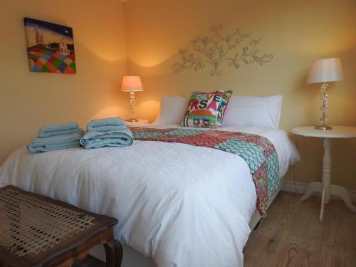 a bedroom with two beds with towels on the bed at Julsie's Home in Reebok