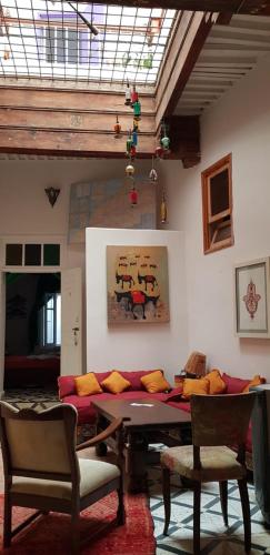 a living room with a table and a couch at Dar Zerhoune in Moulay Idriss Zerhoun