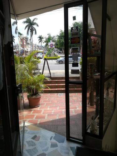 an open door of a store with a view of a street at HOTEL COSTA DEL SOL FUSAGASUGa in Fusagasuga