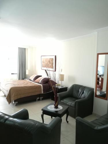 a living room with a couch and a bed at HOTEL COSTA DEL SOL FUSAGASUGa in Fusagasuga