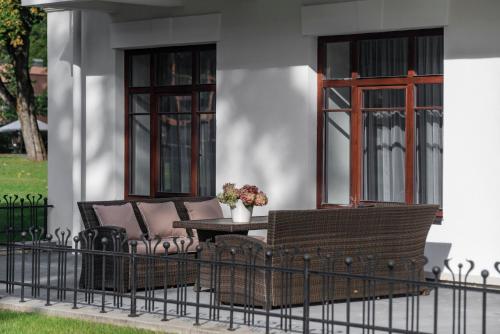 a patio with two chairs and a table and two windows at BURMISTRO NAMAS in Druskininkai