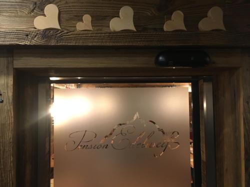 a mirror with a wooden frame with hearts on it at Pension und Apartment Edelweiß in Heiligenblut