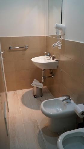 a bathroom with a sink and a toilet at Donna Vicenza Bed & Breakfast in Naples