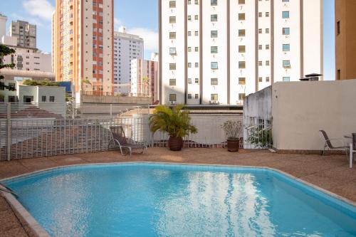 a swimming pool on the roof of a building at Royal Center Hotel Lourdes in Belo Horizonte