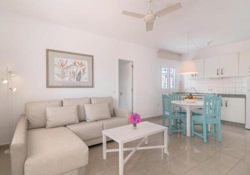 a living room with a couch and a table at Apartamentos Parque Tropical en Lanzarote in Puerto del Carmen