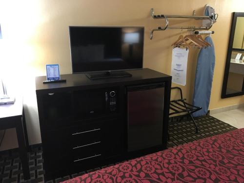 a flat screen tv on a dresser in a hotel room at Days Inn by Wyndham Sarasota Bay in Sarasota