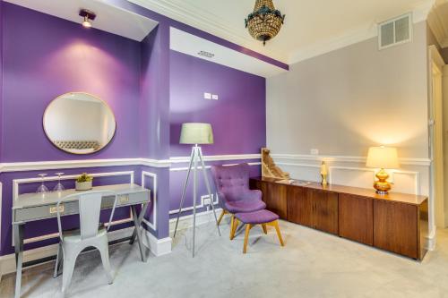 a purple room with a vanity and a mirror at Ruby Room in Chicago