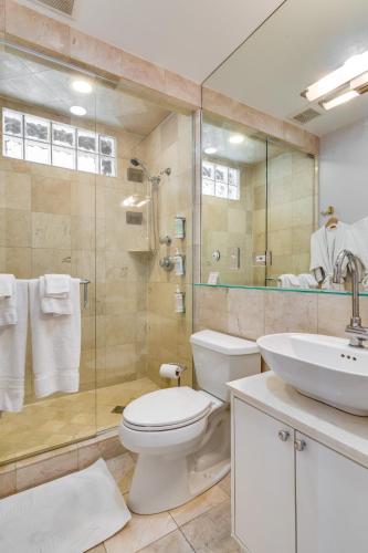 a bathroom with a toilet and a shower and a sink at The Golden Arm in Chicago