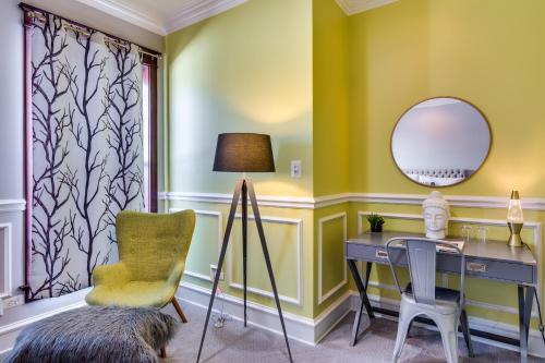 a room with a desk and a chair and a mirror at The Golden Arm in Chicago