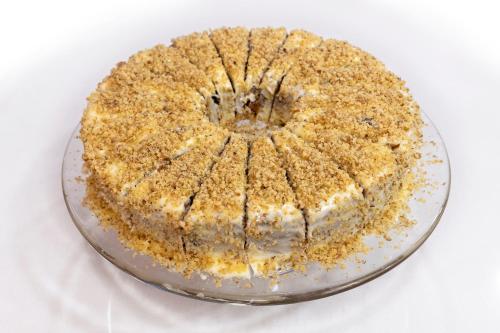 a cake on a glass plate on a table at Castello Hotel in Rio