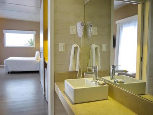 a bathroom with a sink and a mirror at Atlántico Boutique Hotel in Punta del Este
