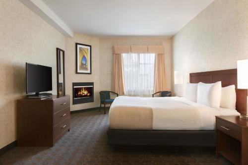 a hotel room with a bed and a television at Days Inn by Wyndham Ottawa Airport in Ottawa