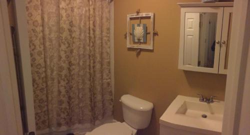 a bathroom with a toilet and a sink at Stunning Empire State 3 BR'S in Union City