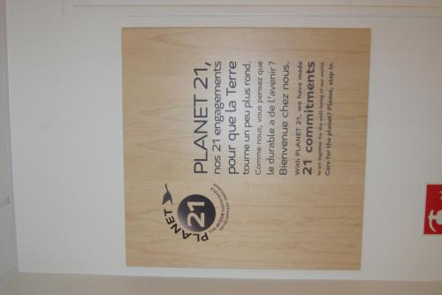 a sign on a wall with writing on it at ibis Le Mans Est Pontlieue in Le Mans