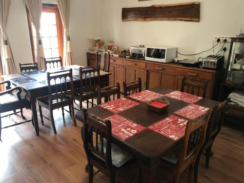 a kitchen with a table and chairs and a kitchen with a table and a kitchen at Towerzicht Guest House in Ladismith