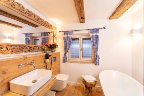 a bathroom with a white sink and a toilet at exklusives Alpenchalet mit Jacuzzi & Sauna für bis zu 14 Personen in Bayrischzell