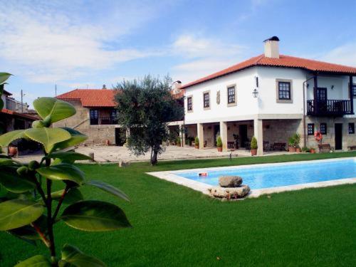 a house with a swimming pool in front of a house at Casa do Meio do Povo - Turismo de Habitação in Chaves