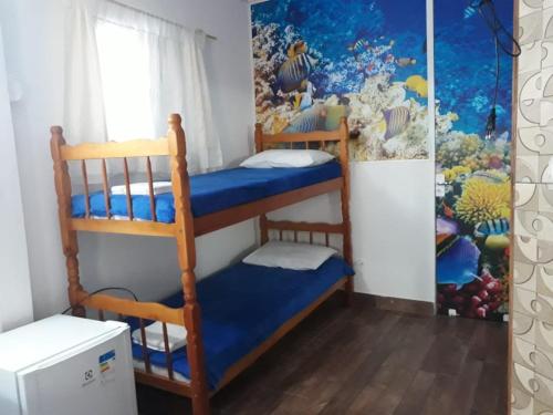 a bedroom with two bunk beds in a room at Hospedaria Gaúcha in Penha
