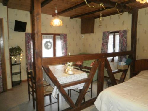 a bedroom with a table and a bed in a room at Gites Petermann in Marckolsheim