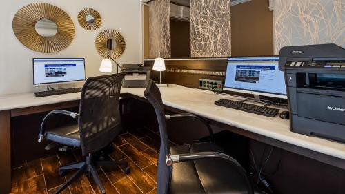 an office with a desk with two computer monitors at Best Western Corvallis in Corvallis