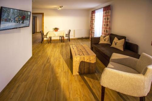 a living room with a couch and a table at Haus Mariandl in Nesselwängle