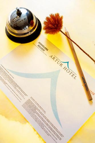 a pen sitting on top of a piece of paper at Artur Hotel in Canakkale