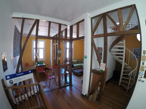 a living room with a spiral staircase and a living room at Lemuria Hostel in Valparaíso