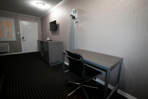 a room with a chair and a table in it at Alpha Inn and Suites in San Francisco