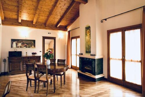 a dining room with a table and a fireplace at Villa Teresa in Limone Piemonte