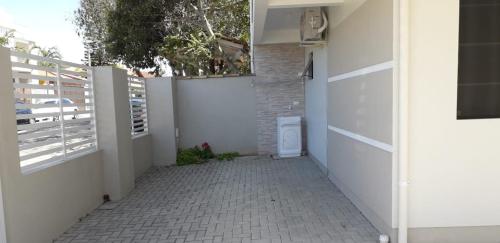 a hallway of a house with a white fence at Residencial Franca Garopaba in Garopaba