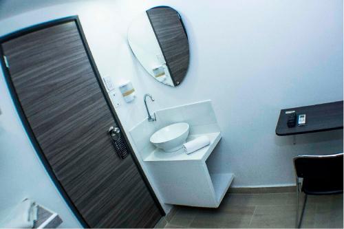 a bathroom with a toilet and a mirror on the wall at Element Hotel in Medellín