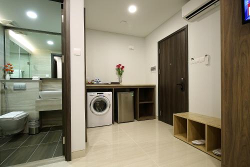 a bathroom with a washing machine and a sink at Aurora Western Village in Ho Chi Minh City