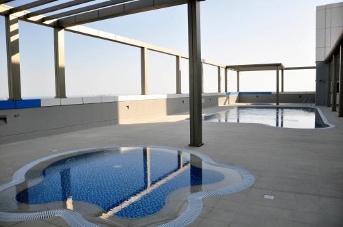 a swimming pool on the roof of a building at Gulf Executive Hotel & Residence Juffair in Manama
