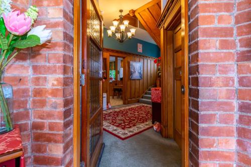 a hallway of a home with a brick wall at The Ocean Breeze CBD in Timaru