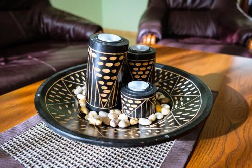 a black plate with three candles on a table at Hotel Vangogh in Qyzylorda