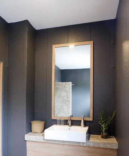 a bathroom with a sink and a mirror at Sweed Dreams Hotel in Ko Lipe