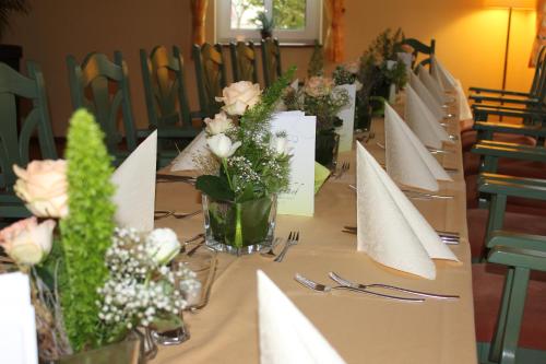 a long table with flowers and cards on it at Lindenhof in Thiendorf