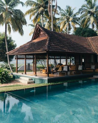 a pavilion by the pool at a resort at Vismaya by Moksha Stays in Turavūr