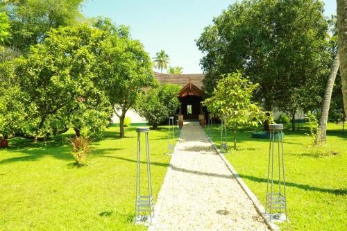 a path leading to a gazebo in a park at Vismaya by Moksha Stays in Turavūr