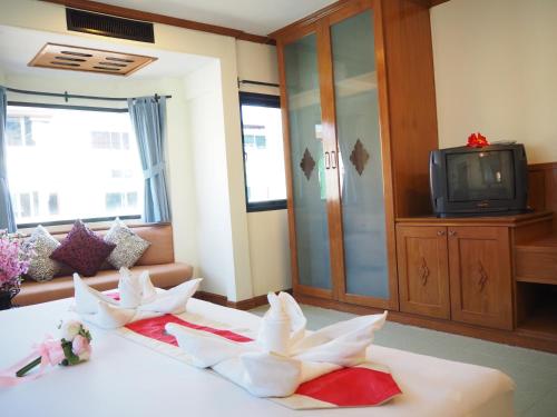 a living room with two swans on a table at Your Place Inn in Karon Beach