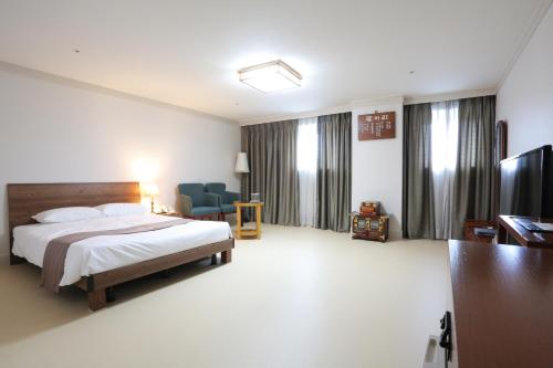 a hotel room with a bed and a television at Daegu AW Hotel in Daegu