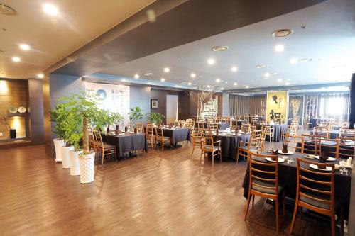 a dining room with tables and chairs in a room at Daegu AW Hotel in Daegu