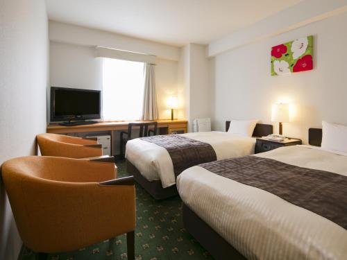 Un ou plusieurs lits dans un hébergement de l'établissement Premier Hotel-CABIN-Sapporo