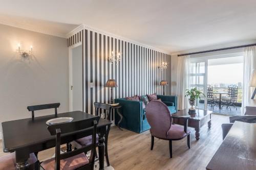 a living room with a couch and a table at Romney Park Luxury Apartments by The Stay Collection in Cape Town