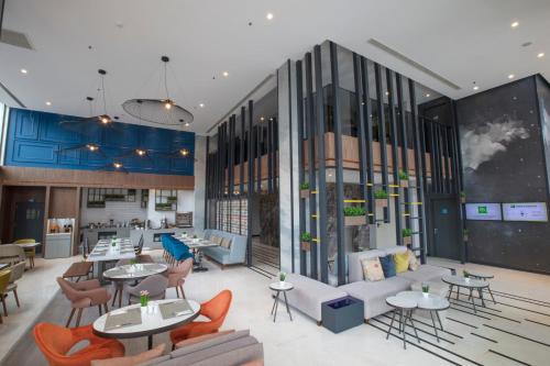 a rendering of a restaurant with tables and chairs at ibis Styles Izmir Bornova in Izmir